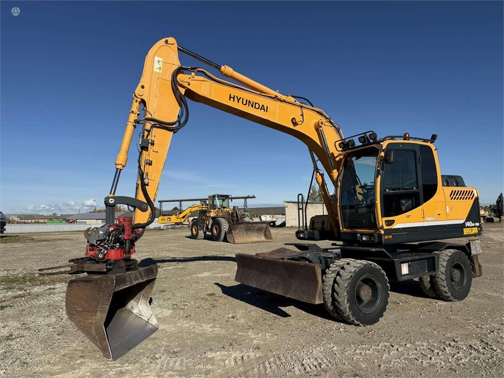 Hyundai Robex 140 W-9A Rototilt + grap - Колёсный экскаватор: фото 1 Hyundai Robex 140 W-9A Rototilt + grap - Колёсный экскаватор: фото 1