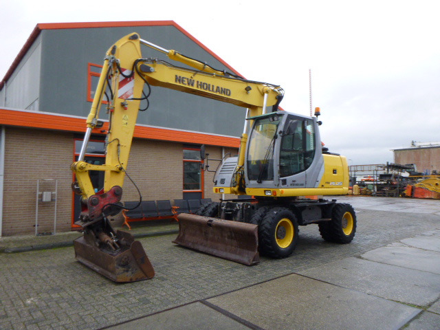 NEW HOLLAND MH PLUS - Колёсный экскаватор: фото 1 NEW HOLLAND MH PLUS - Колёсный экскаватор: фото 1