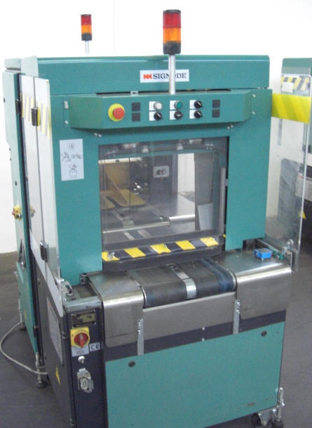 Signode Newsmaster 5500 cross strapping machines - Упаковочное оборудование: фото 1 Signode Newsmaster 5500 cross strapping machines - Упаковочное оборудование: фото 1
